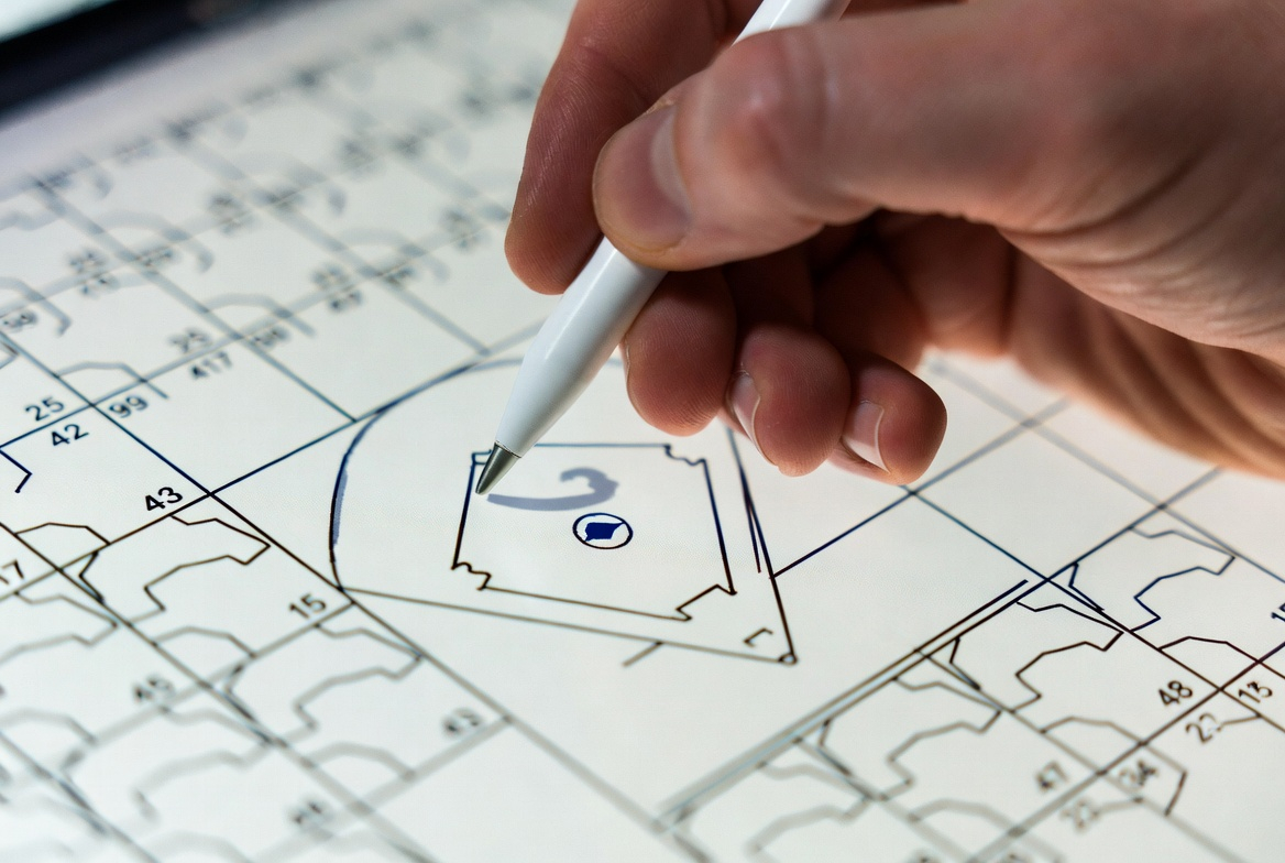 Close view of a hand marking a baseball scorecard